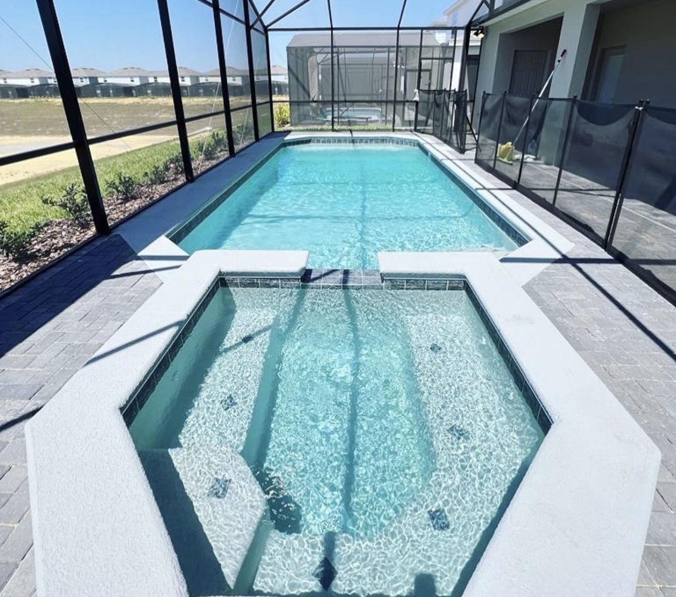 Screened pool and spa with paver deck in Central Florida