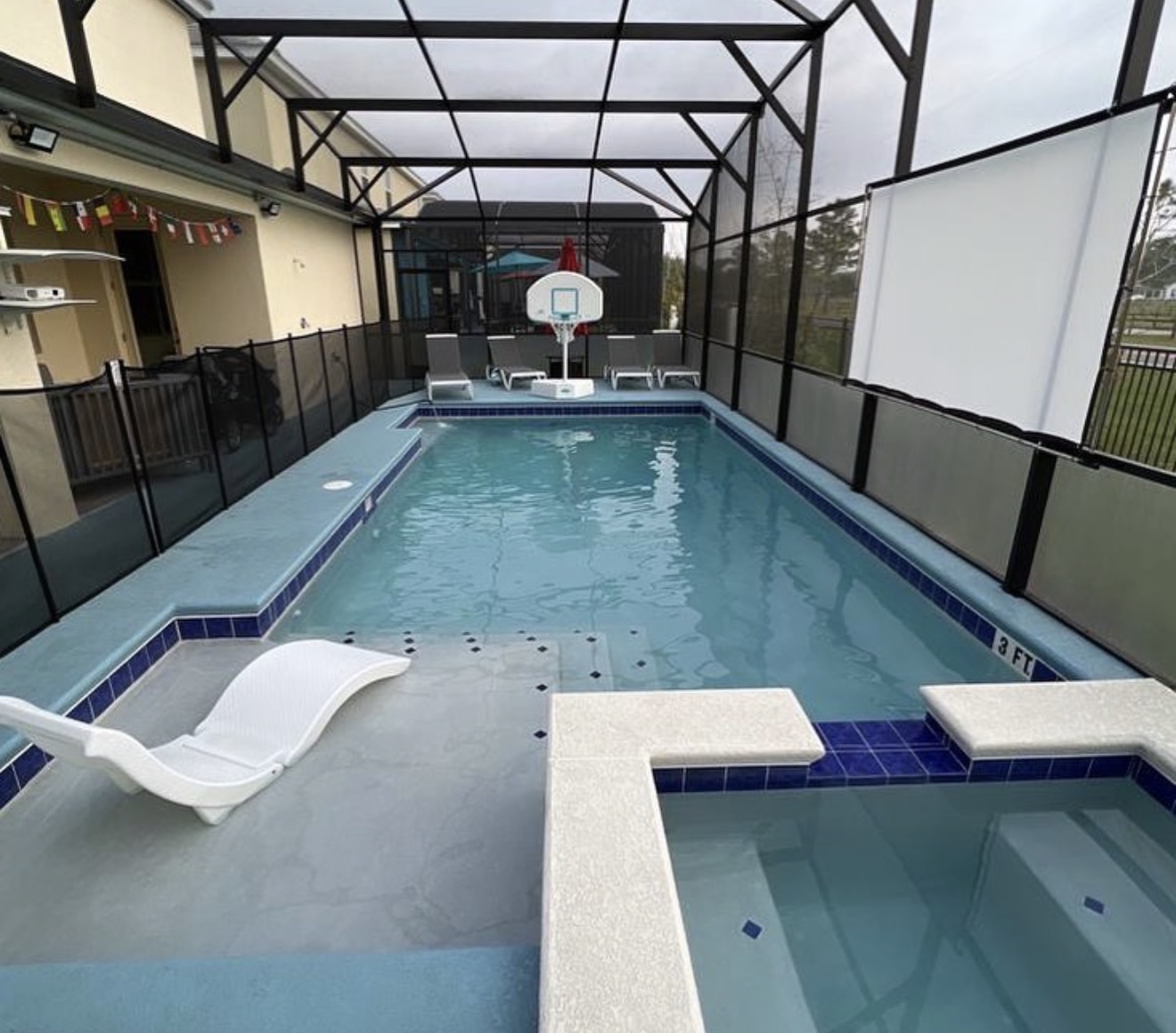 Screened lap pool with spa and safety fence